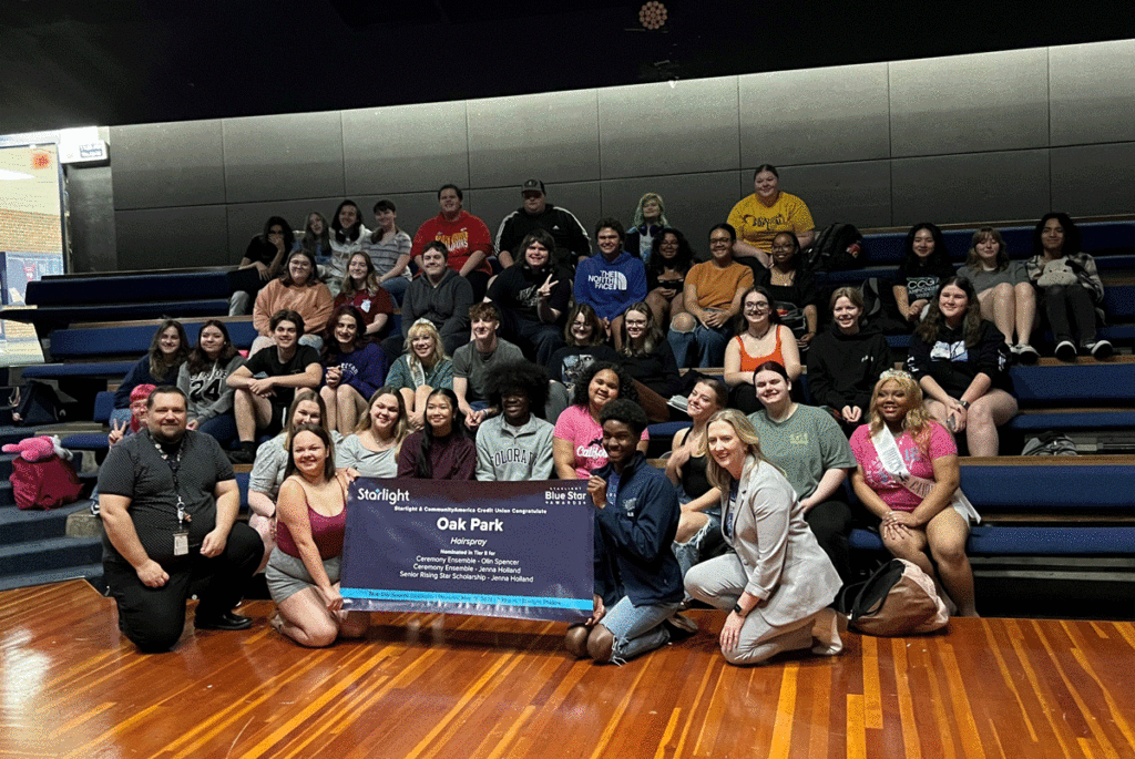 Students from Oak Park High School sitting in the auditorium with a banner announcing their nominations.