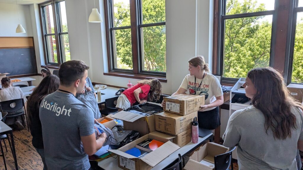 4 Interns helping pack graduation bags at Literacy KC