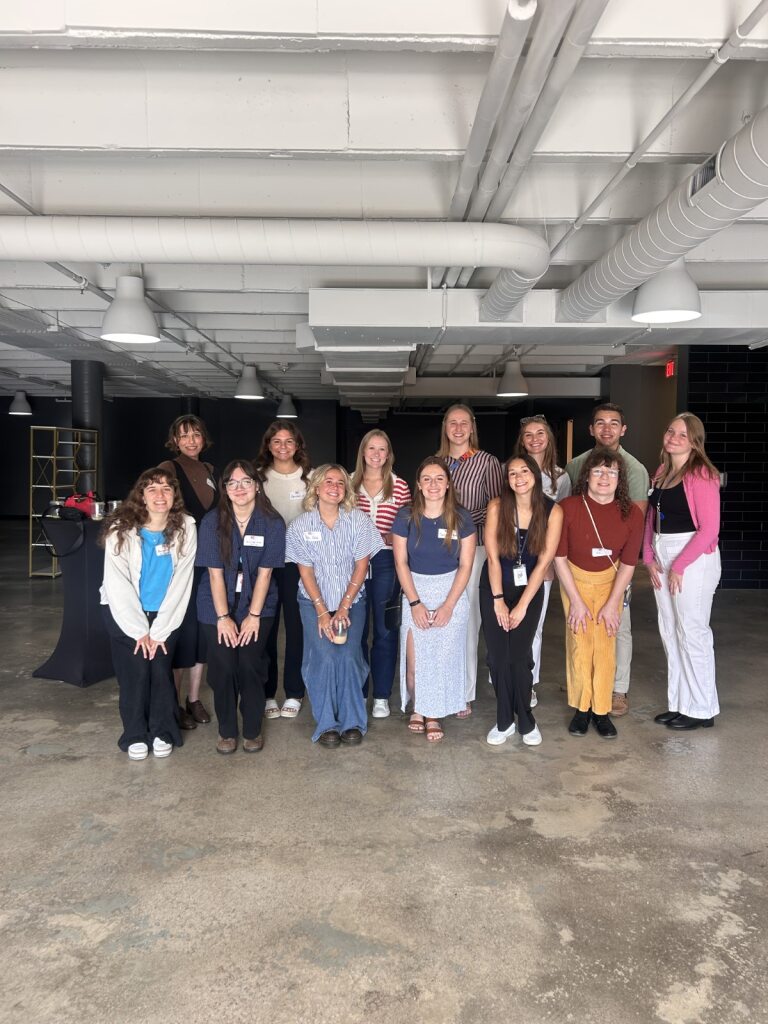 Group of interns at a networking event smiling in a group