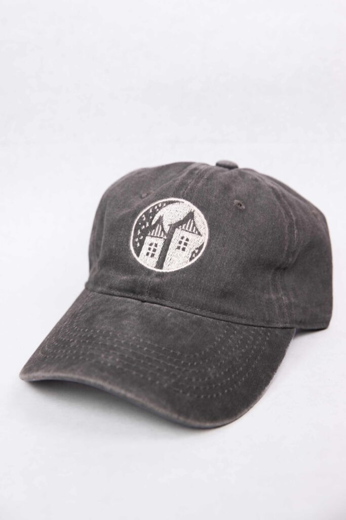 A gray baseball hat with the Starlight logo in the center of the hat. The hat lays on a white background.