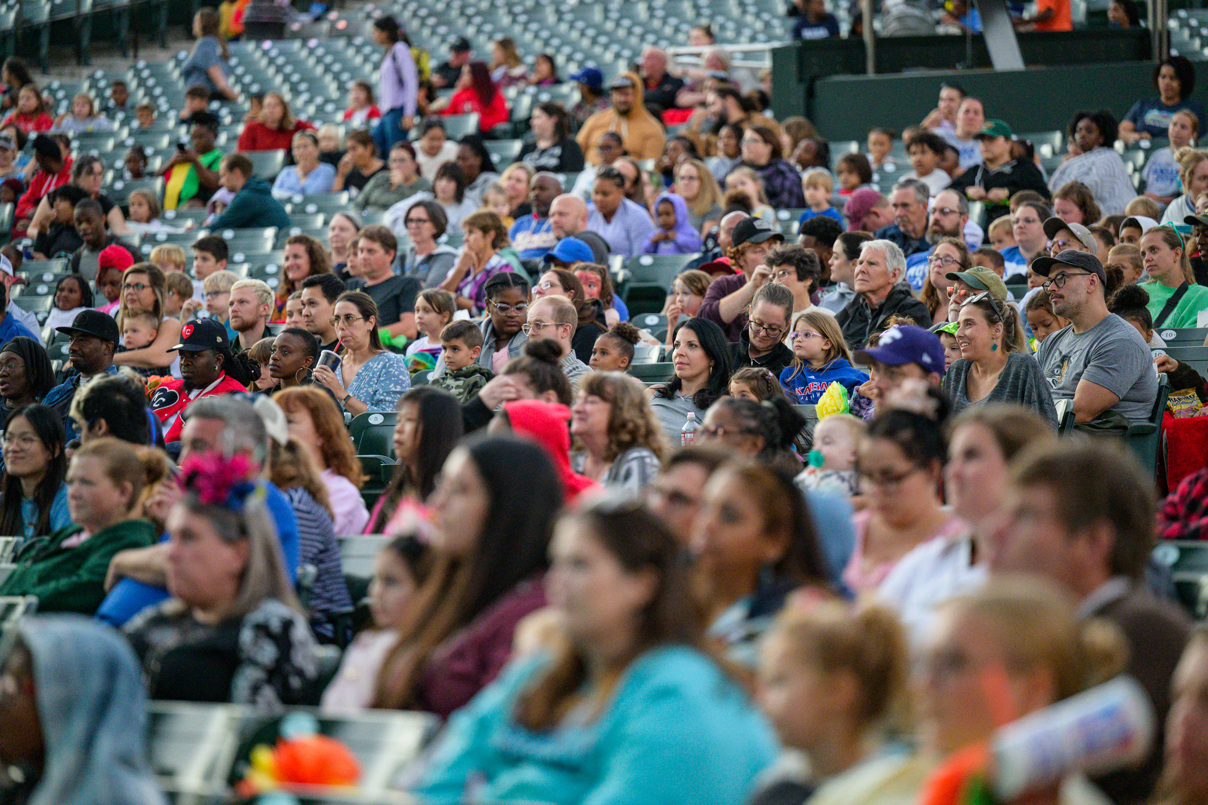 A large group of people sitting in the audience for a Starlight show all watching the stage.