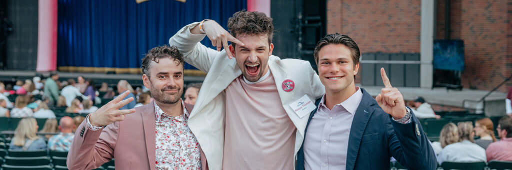 Three guys stand together at Starlight.