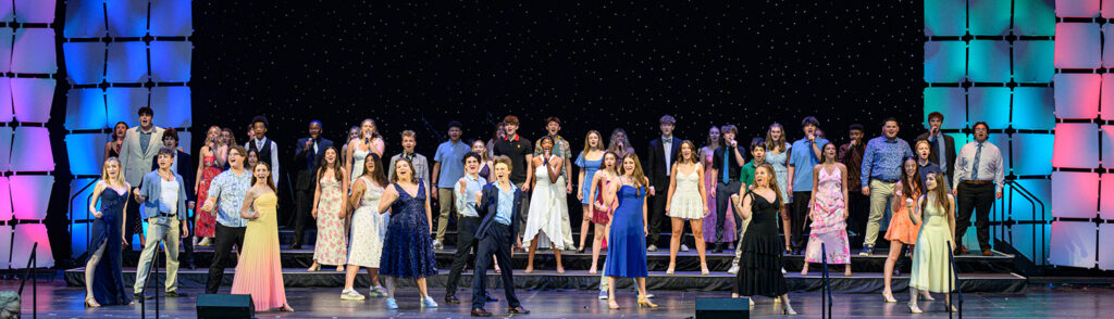 A group of students perform on stage.