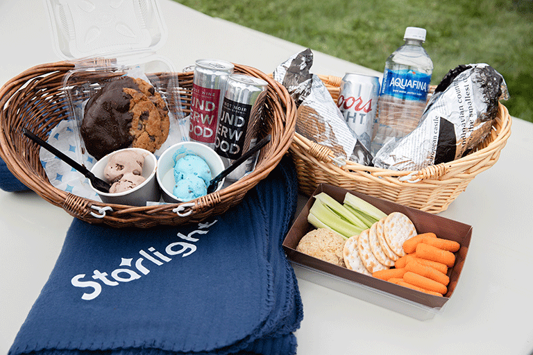 Two wicker baskets filled with food and drinks.