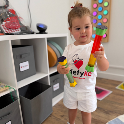 Young girl plays with toys in the Sensory Room.