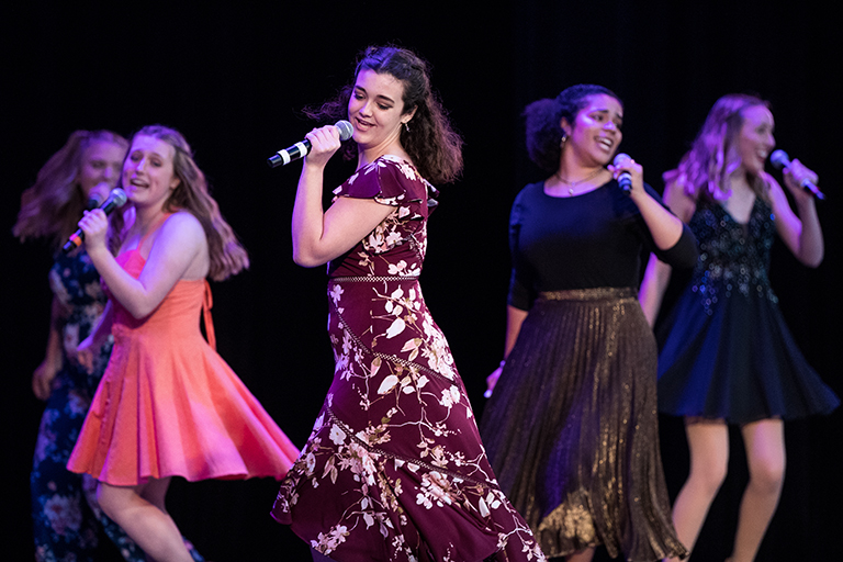 Students dancing and singing at Blue Star Awards