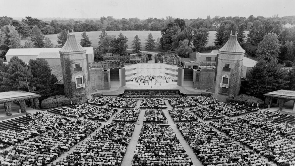 Black and white photo of a full audience watching a show