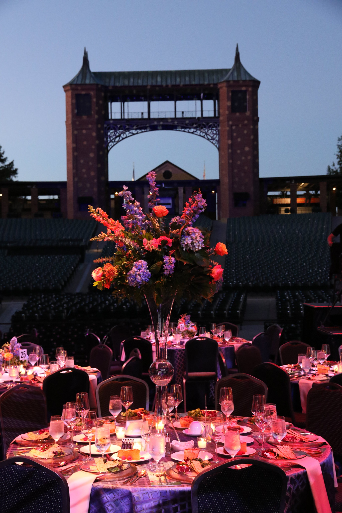 Flowers on a table set for the gala with the light tower in the background
