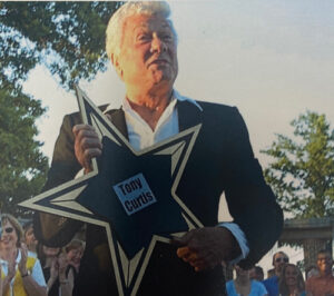 Tony Curtis holding his star from the Starlight ceremony